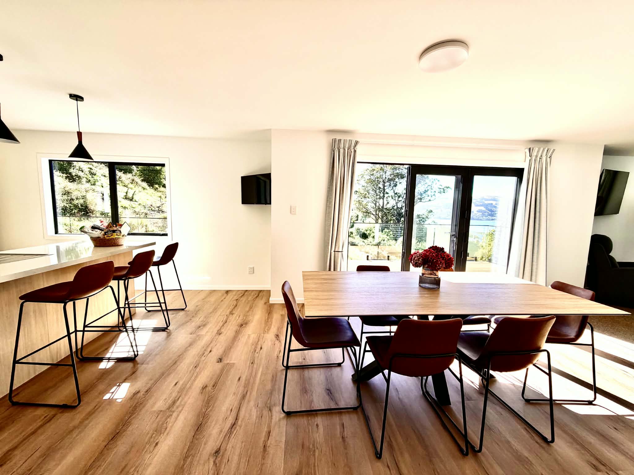 Bright open-plan dining area opening onto the deck